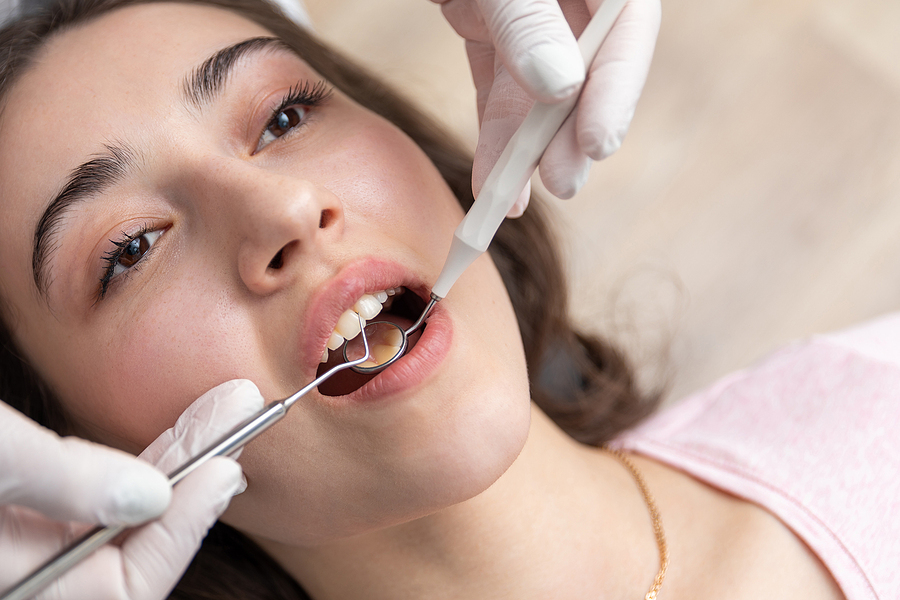Dental Check Up In Dential Clinic. Dentist Examining Patient Tee Dental Check Up In Dential Clinic. Dentist Examining Patient Tee