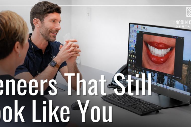 doctor smiling with patient looking at after photos