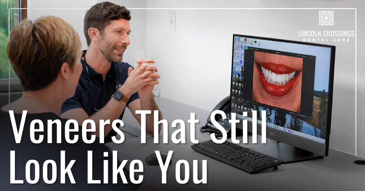 Veneers That Still Look Like You doctor smiling with patient looking at after photos